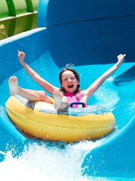 Child enjoying a water slide at Bayou Lagoon Water Park.