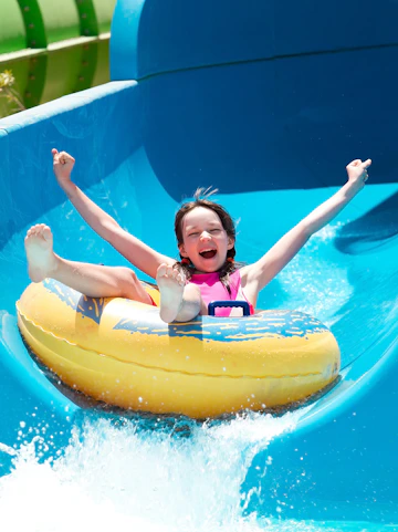 Child enjoying a water slide at Bayou Lagoon Water Park.