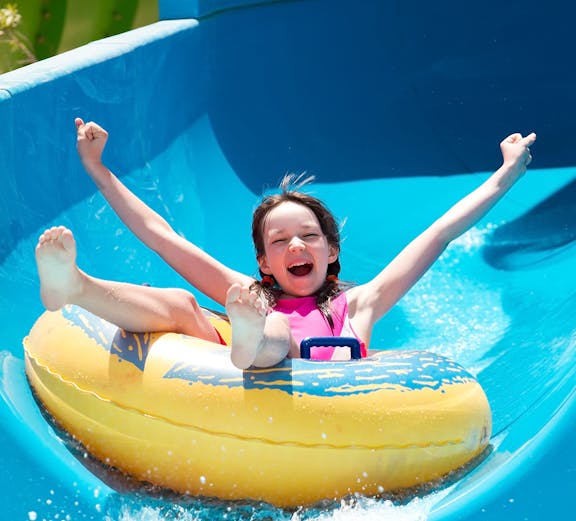 Child enjoying a water slide at Bayou Lagoon Water Park.