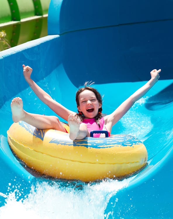 Child enjoying a water slide at Bayou Lagoon Water Park.
