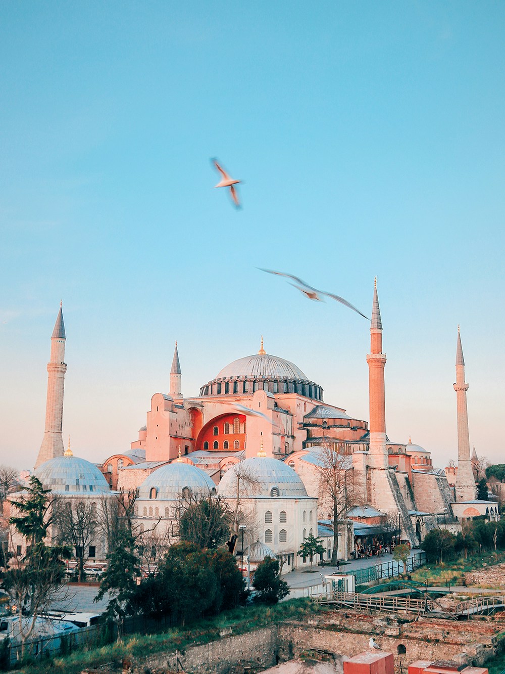 Hagia Sophia exterior view in Istanbul with tourists exploring the historic site.
