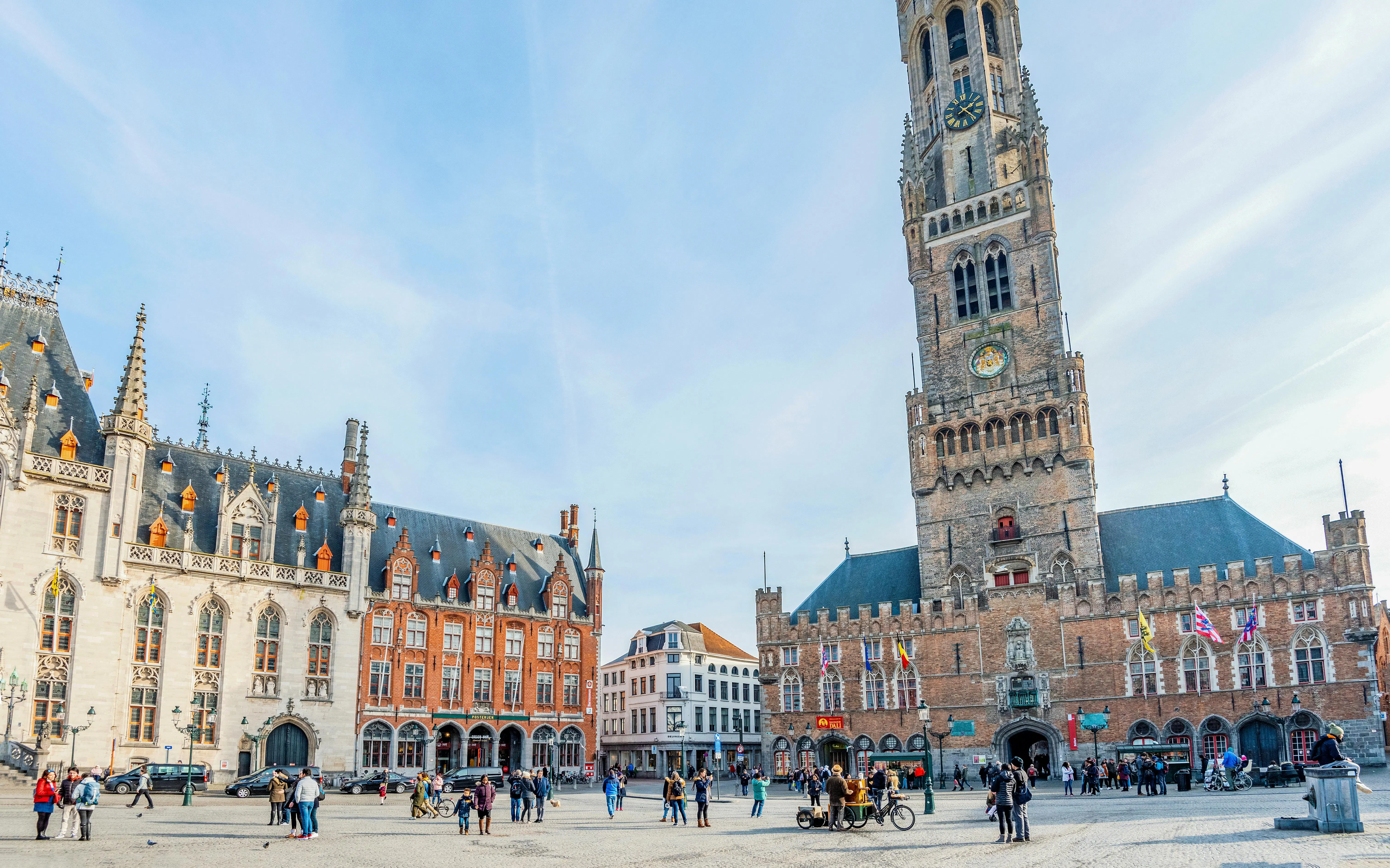 Belfort tower in Bruges, Belgium, with people in the square below.