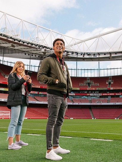 Visitors exploring Emirates Stadium in London.
