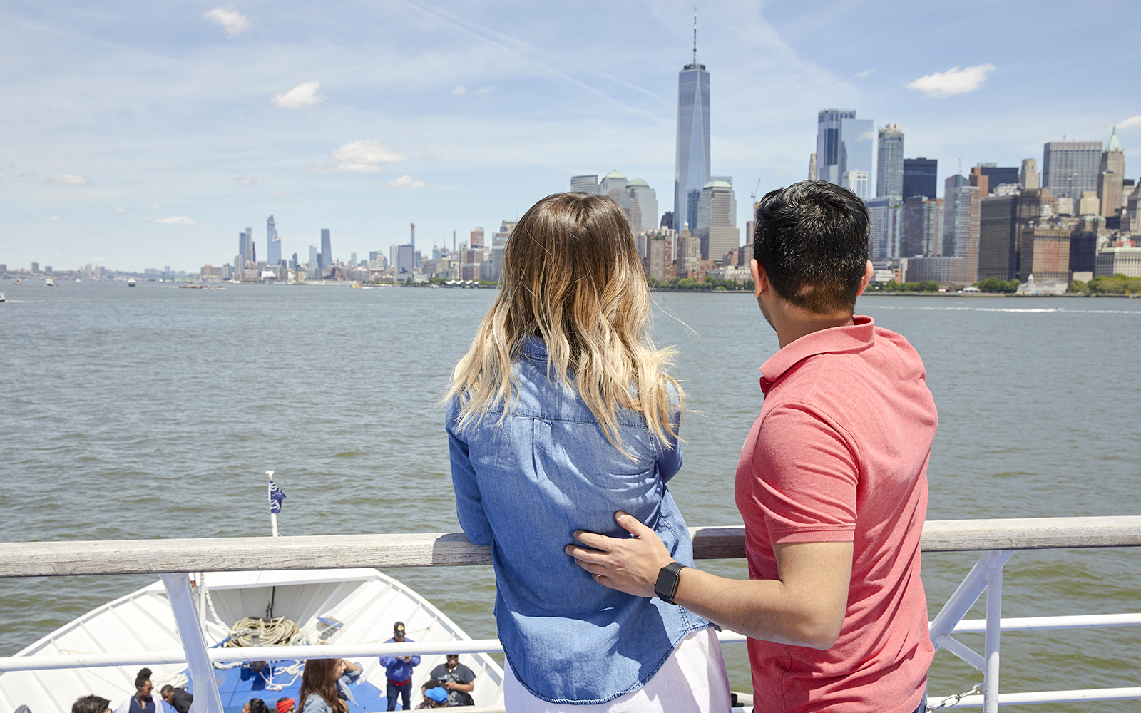 Couple enjoying New Jersey Signature Cruise with New York City skyline in view.