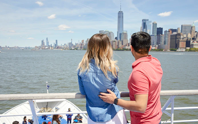 Couple enjoying New Jersey Signature Cruise with New York City skyline in view.