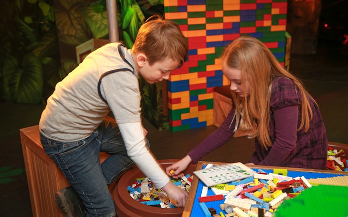 Children building with LEGO bricks at indoor playground, LEGOLAND Discovery Centre Berlin.