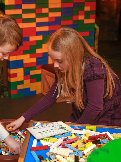 Children building with LEGO bricks at indoor playground, LEGOLAND Discovery Centre Berlin.