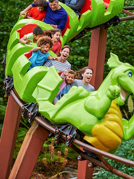 Visitors enjoying a dragon-themed roller coaster at LEGOLAND Windsor Resort.
