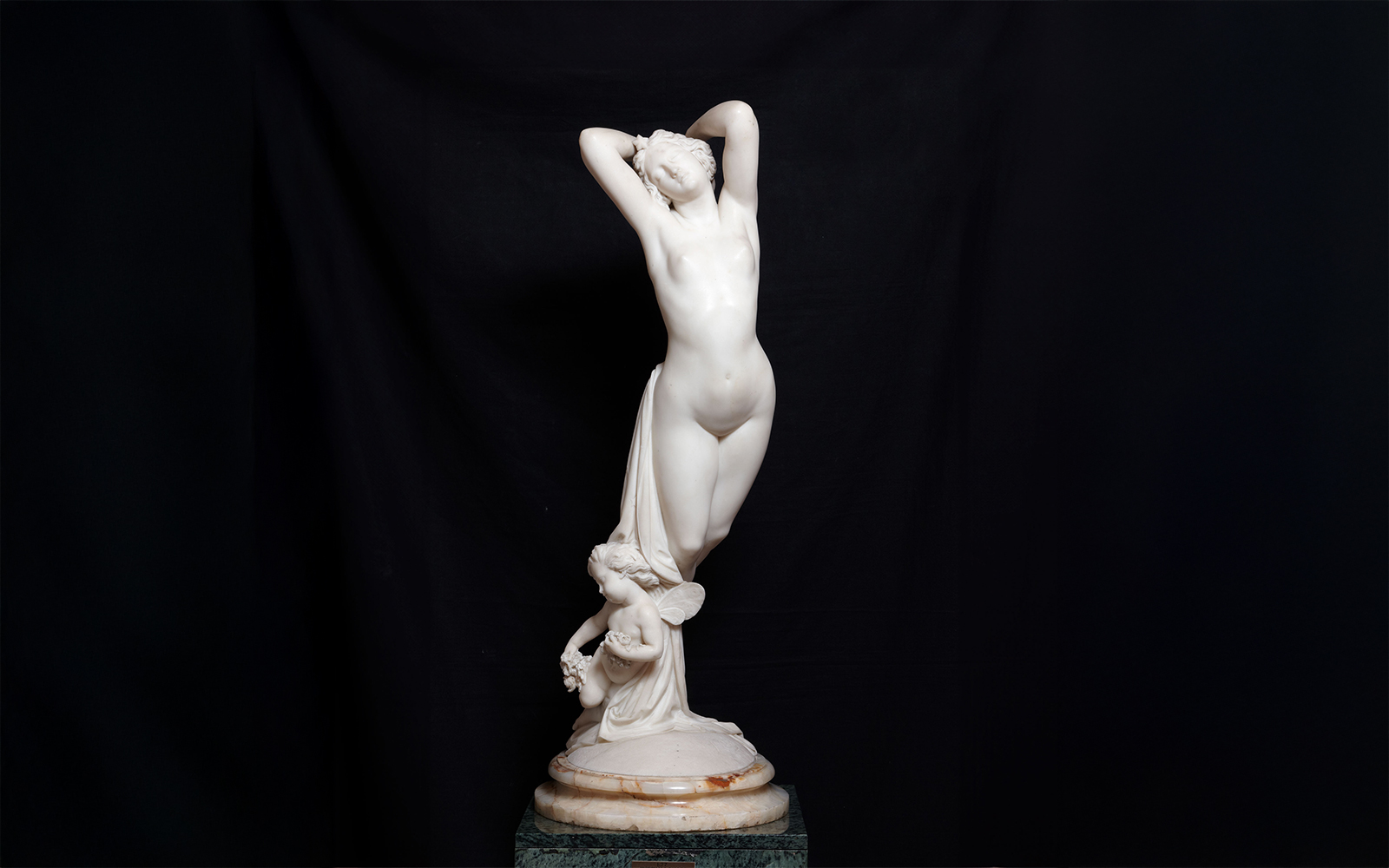 Sculpture of a standing figure with a cherub at Liria Palace.