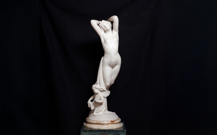 Sculpture of a standing figure with a cherub at Liria Palace.