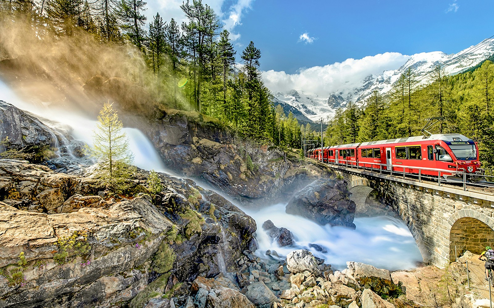 Bernina Express train traveling through Swiss Alps from Chur to Tirano.