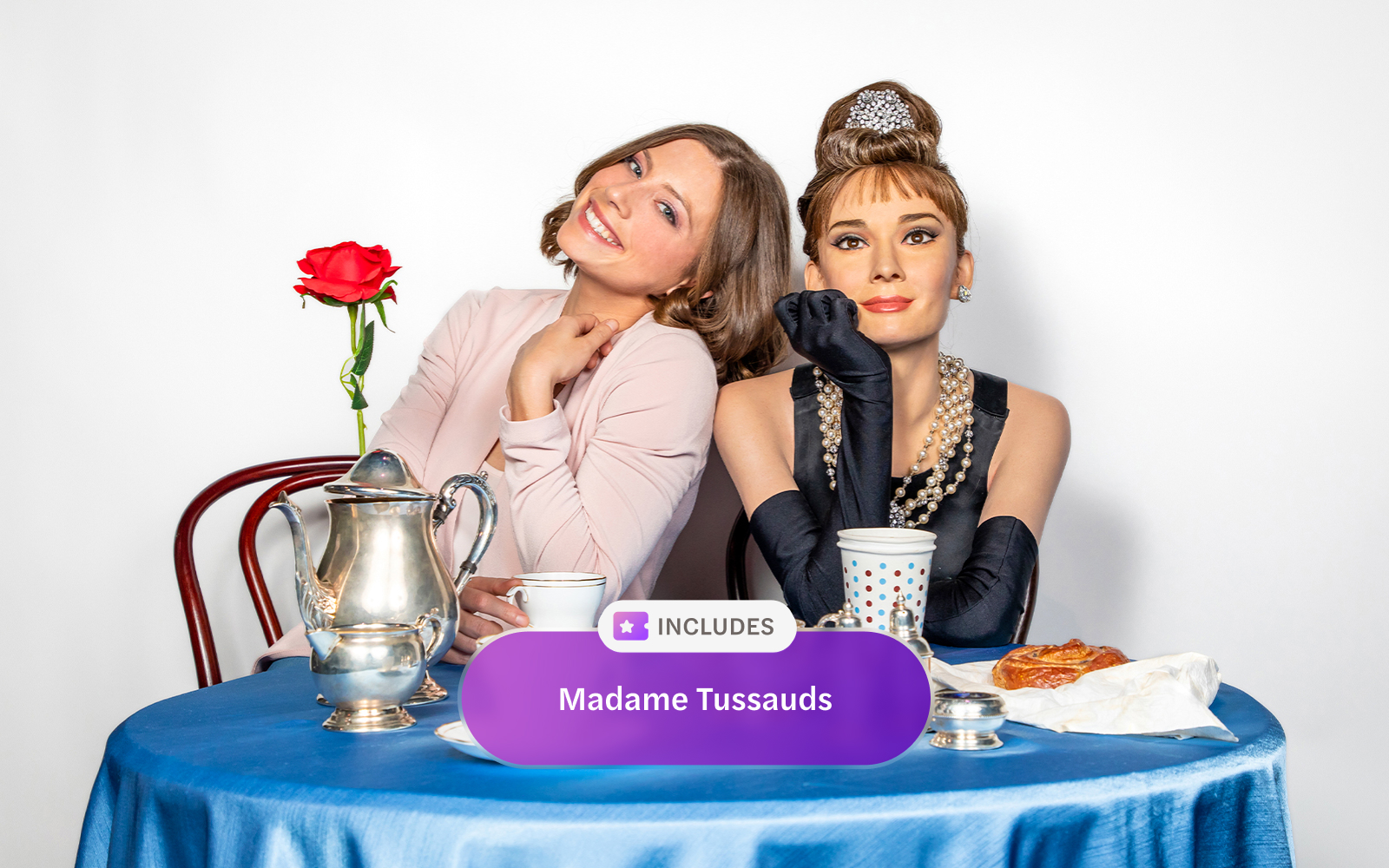 Madame Tussauds New York wax figure with visitor at a tea table.
