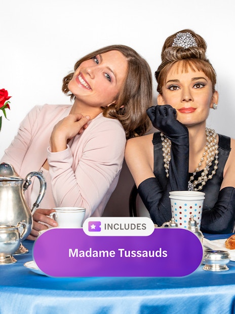 Madame Tussauds New York wax figure with visitor at a tea table.