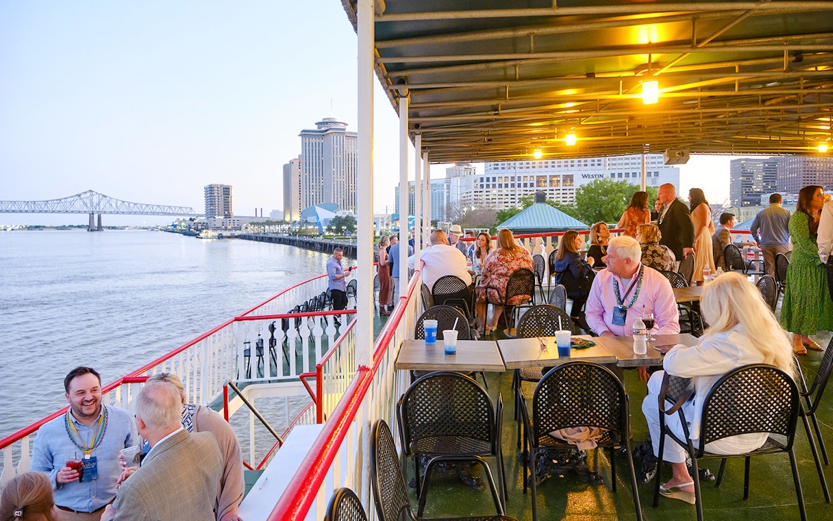 People enjoying the river view from the deck of Steamboat Natchez in New Orleans.