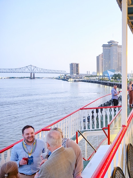 People enjoying the river view from the deck of Steamboat Natchez in New Orleans.