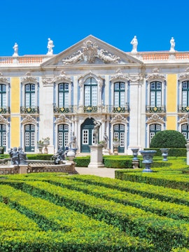 National Palace of Queluz facade and manicured gardens in Lisbon, Portugal.