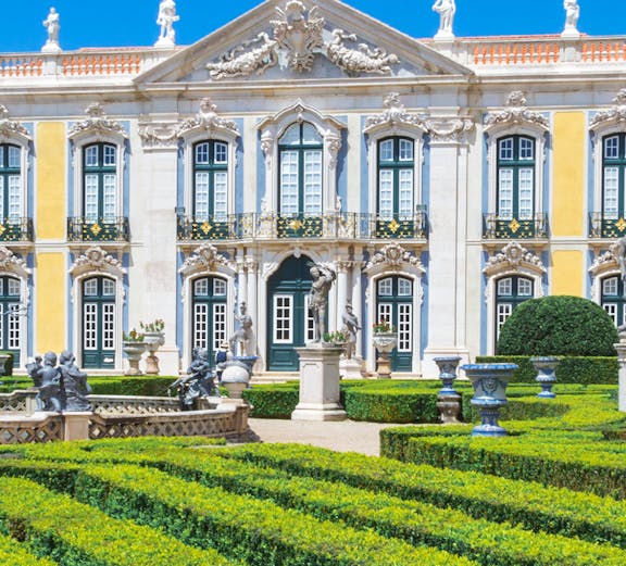 National Palace of Queluz facade and manicured gardens in Lisbon, Portugal.