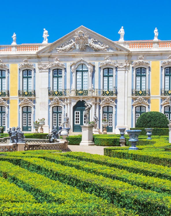 National Palace of Queluz facade and manicured gardens in Lisbon, Portugal.