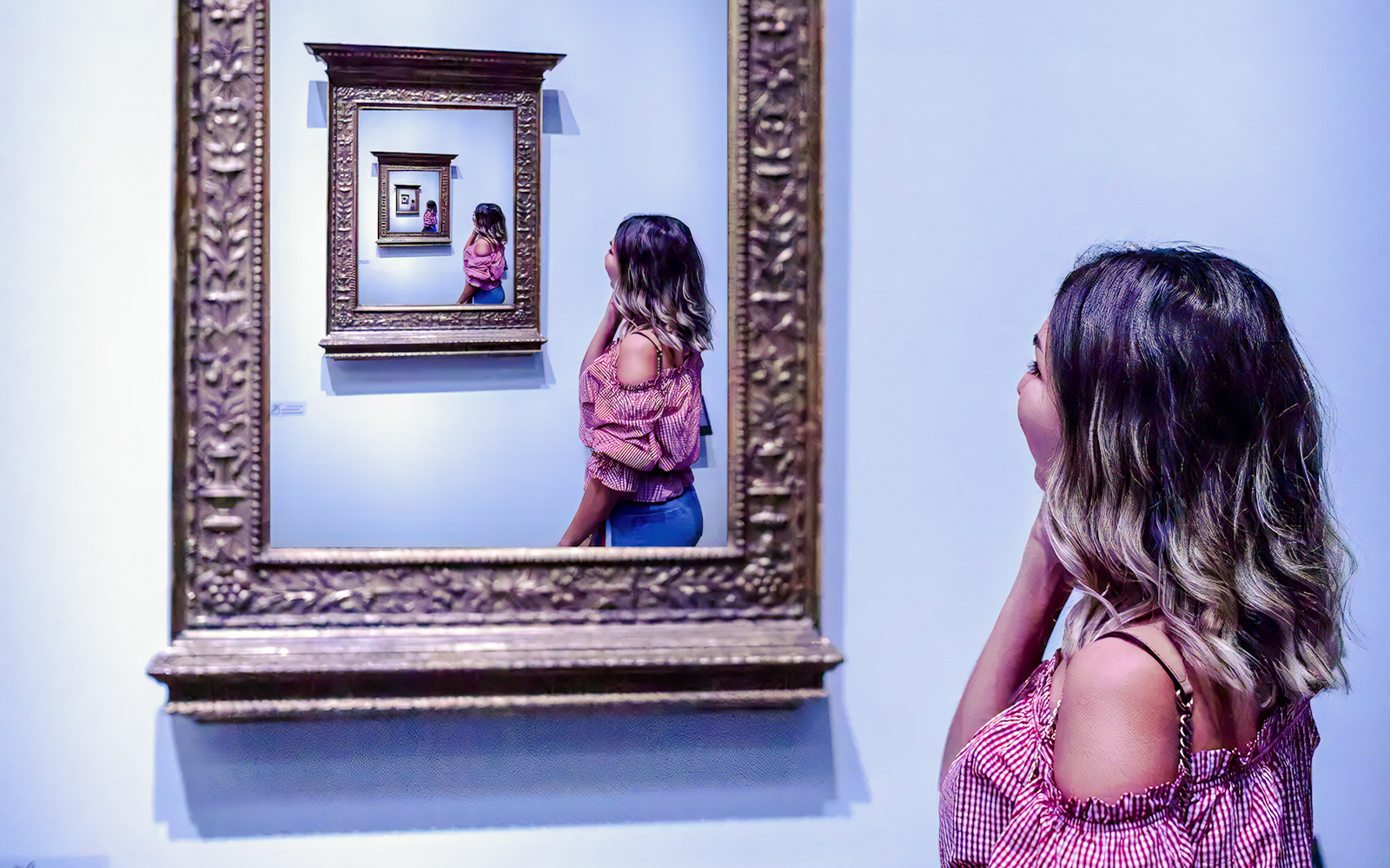 Guest observing an infinite mirror illusion at the World of Illusions.