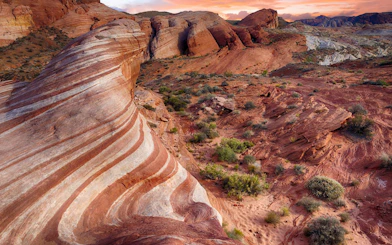 Valley of Fire's striped red rock formations at sunset, Nevada desert landscape.