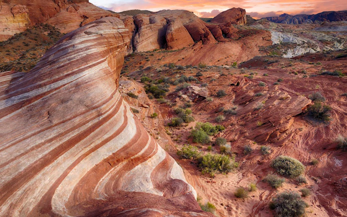 Valley of Fire's striped red rock formations at sunset, Nevada desert landscape.