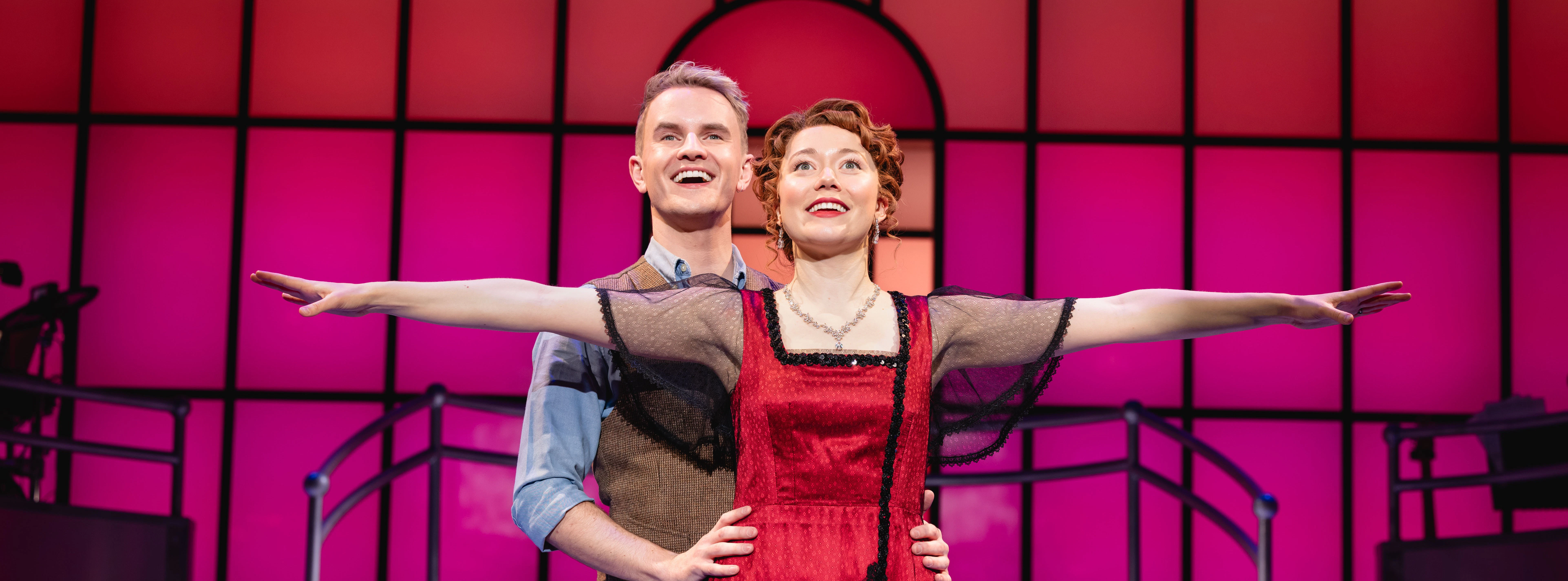 Stage performance of Titanique Westend with actors in embrace on a vibrant set.