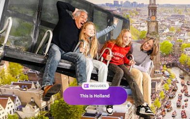 Tourists on 5D ride at This Is Holland, overlooking Amsterdam canals and cityscape.