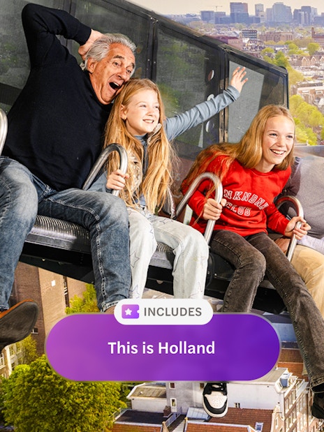 Tourists on 5D ride at This Is Holland, overlooking Amsterdam canals and cityscape.