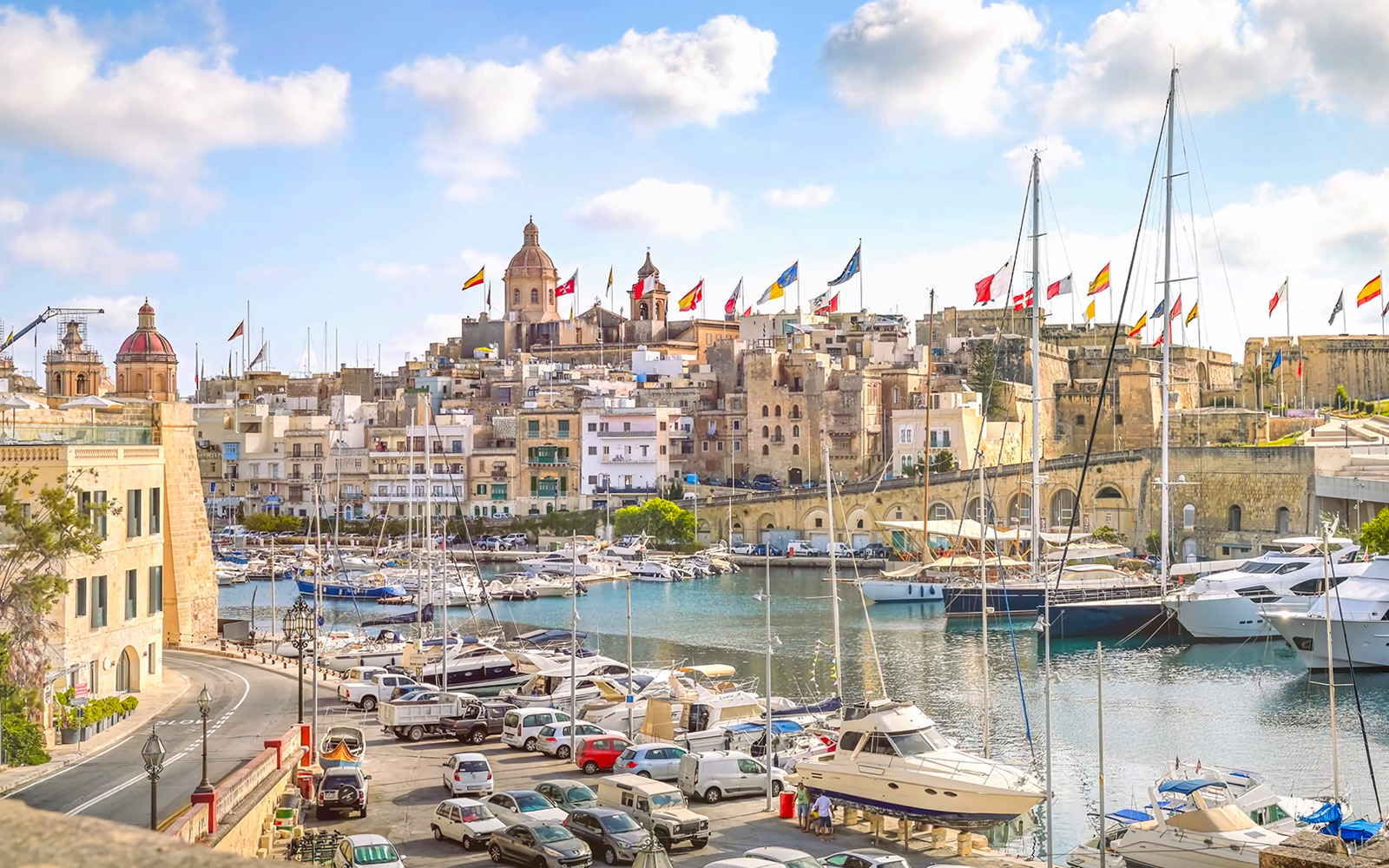Harbor view of The Three Fortified Cities with boats and historic buildings in Malta.