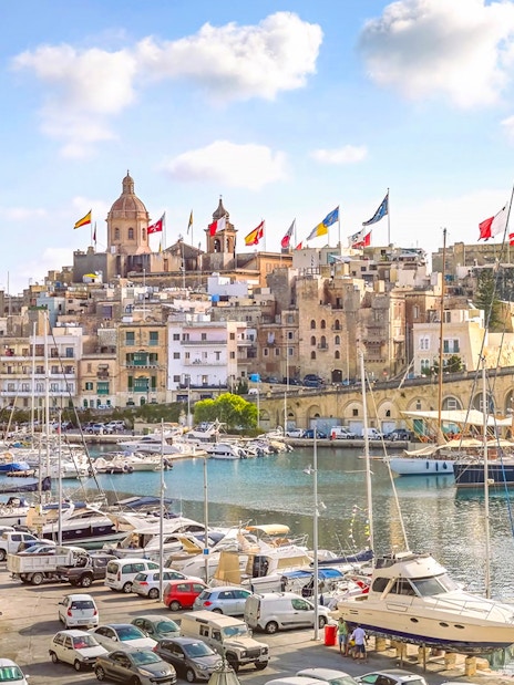 Harbor view of The Three Fortified Cities with boats and historic buildings in Malta.