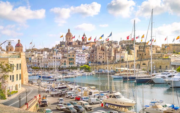 Harbor view of The Three Fortified Cities with boats and historic buildings in Malta.