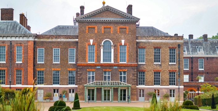 Kensington Palace in London with tourists exploring the historic royal residence.