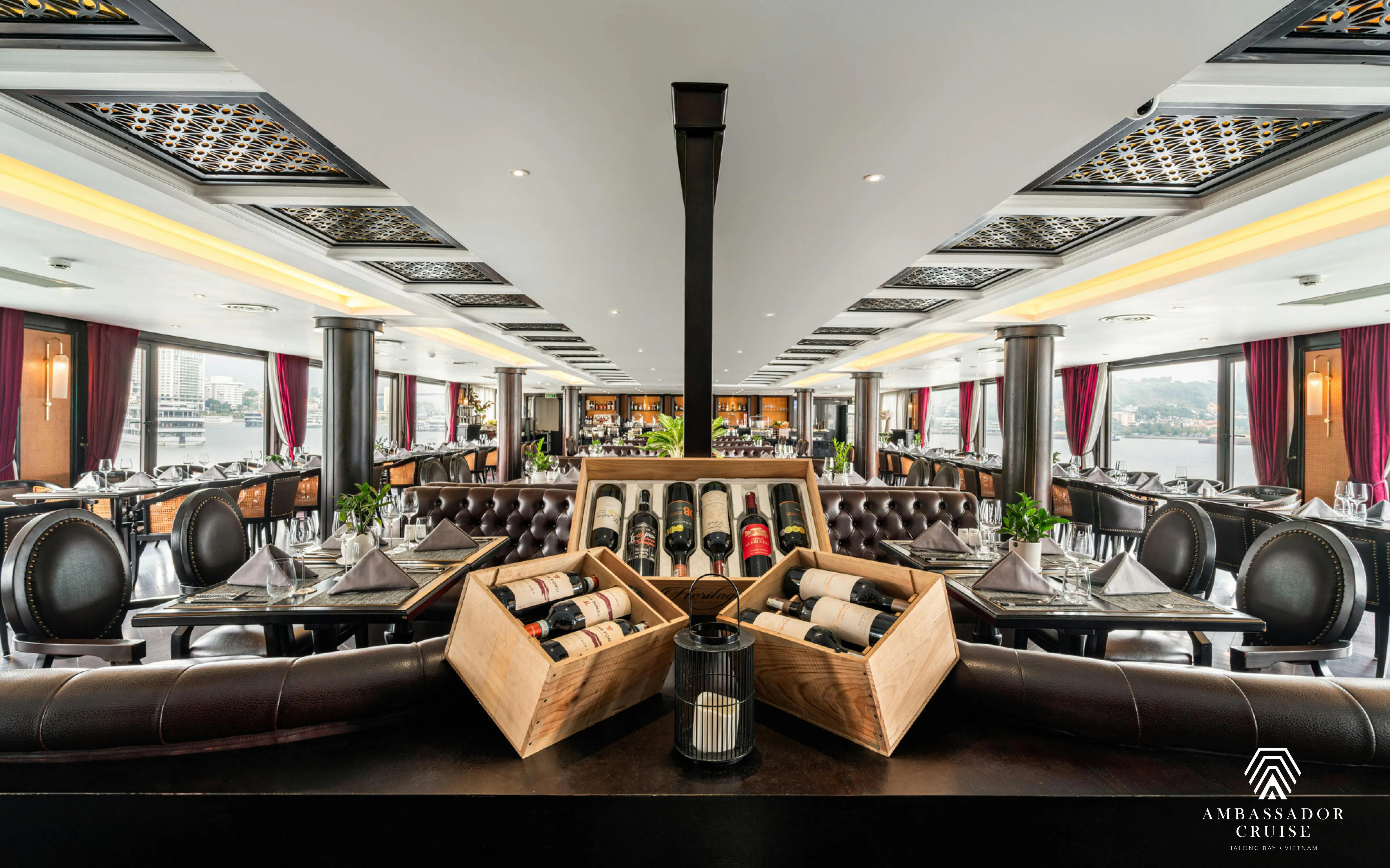 Dining area with wine display on the 5-star Ambassador Cruise in Ha Long Bay, Vietnam.