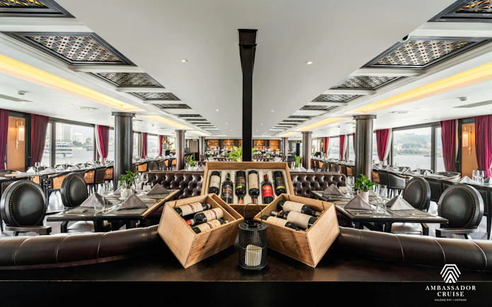 Dining area with wine display on the 5-star Ambassador Cruise in Ha Long Bay, Vietnam.