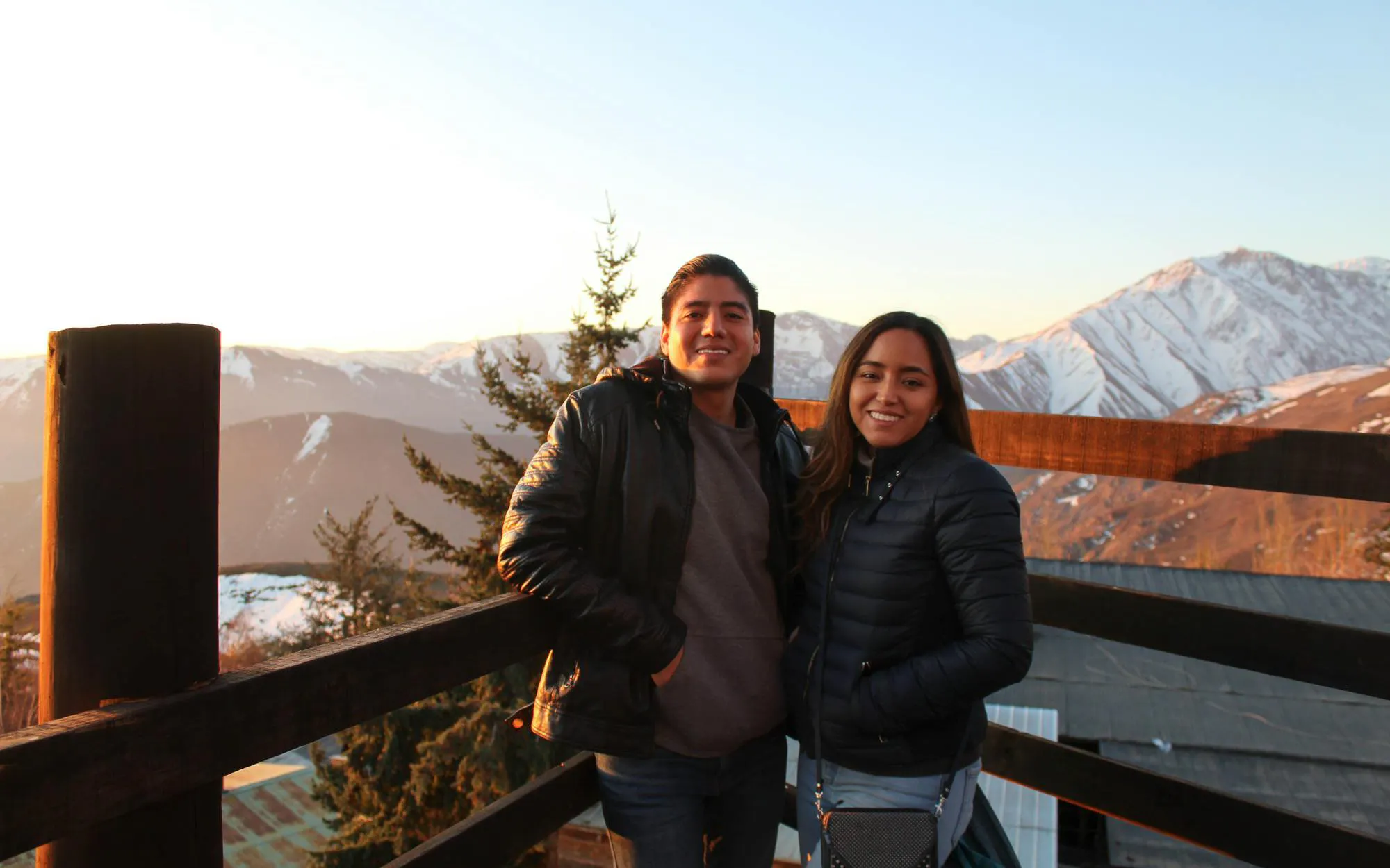 Couple enjoying a view of the Andes mountains at sunset.