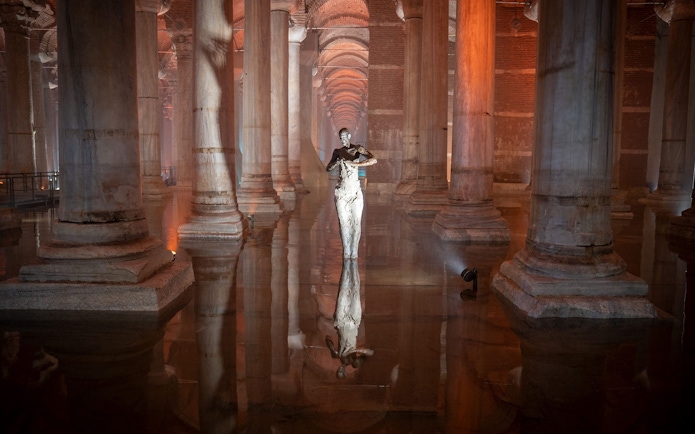 Basilica Cistern interior with columns and reflective water during guided tour in Istanbul.