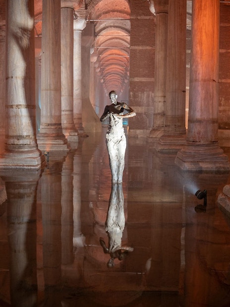Basilica Cistern interior with columns and reflective water during guided tour in Istanbul.