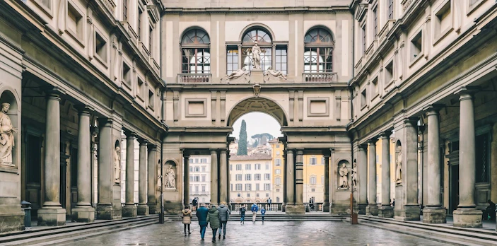 Uffizi Gallery courtyard with visitors in Florence, Italy.