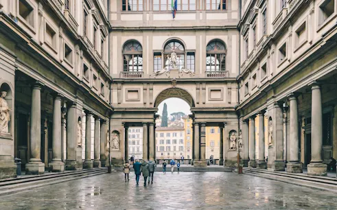 Uffizi Gallery courtyard with visitors in Florence, Italy.