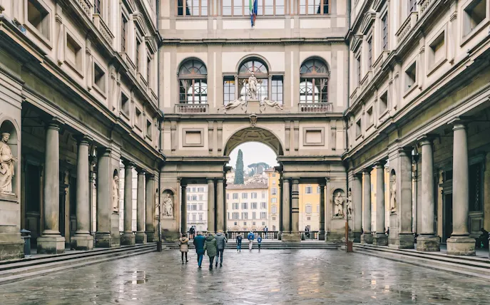 Uffizi Gallery courtyard with visitors in Florence, Italy.
