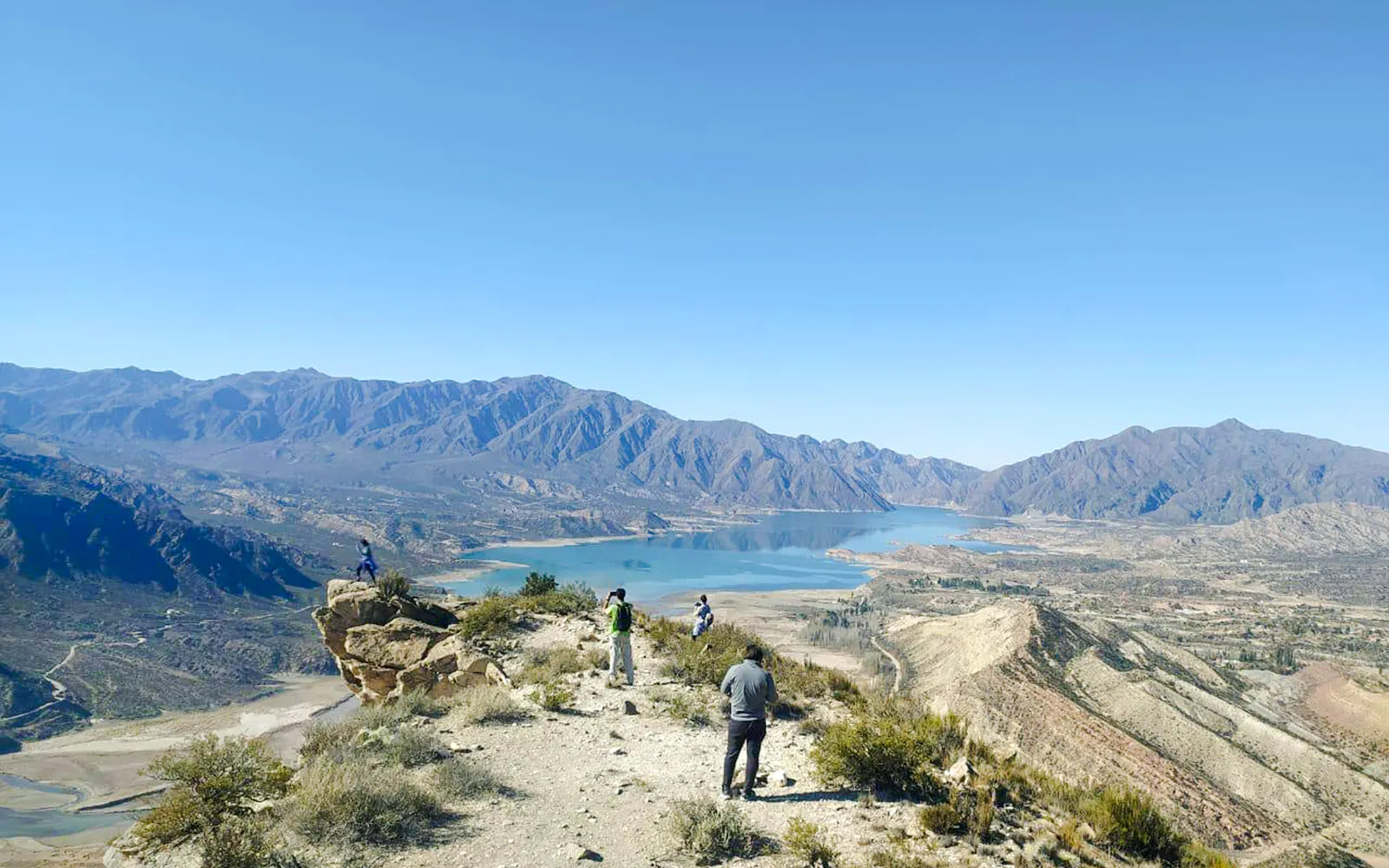 Trekking group at Cerro Bayo, Argentina with mountain and lake views.
