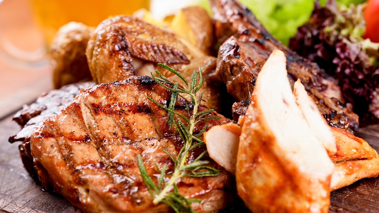 Grilled meats with rosemary garnish