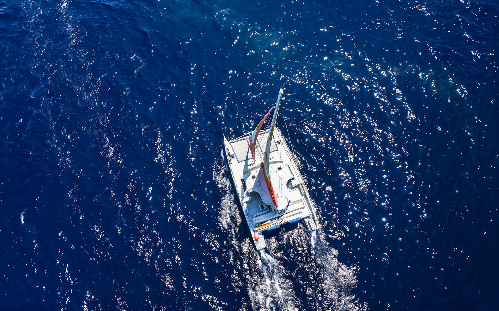 Catamaran sailing on blue ocean near Waikoloa, Big Island.