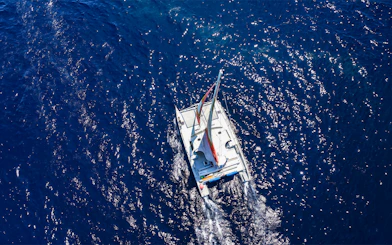 Catamaran sailing on blue ocean near Waikoloa, Big Island.