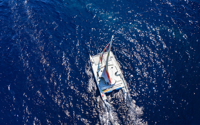 Catamaran sailing on blue ocean near Waikoloa, Big Island.