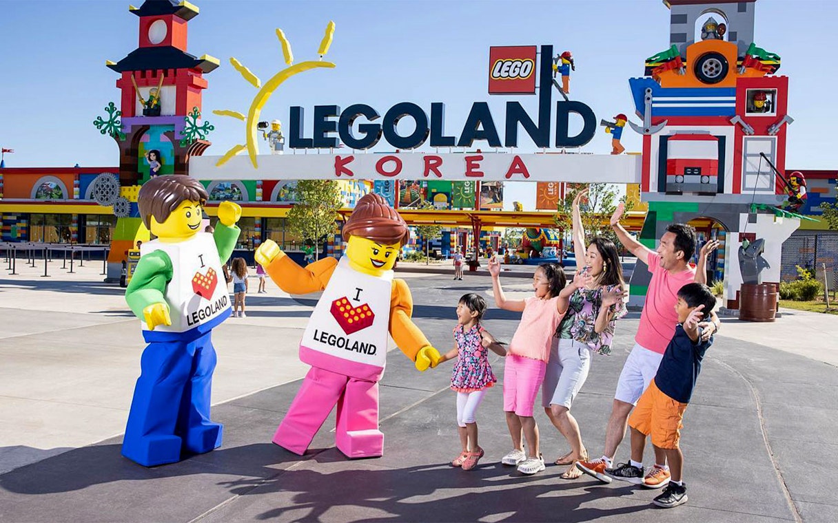 Visitors enjoying LEGO characters at LEGOLAND Korea entrance.