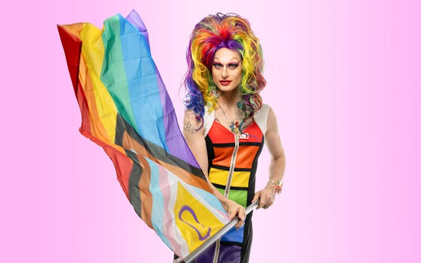 Drag performer with rainbow flag, QueerCityPass Berlin ABC.