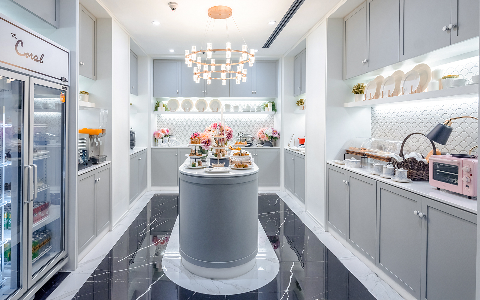 The Coral First Class Lounge buffet area at Bangkok airport, featuring snacks and beverages.