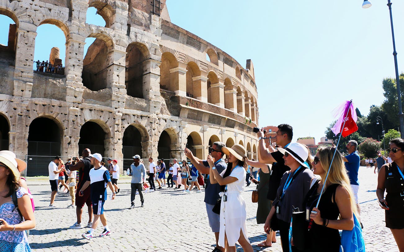Tourists exploring the Colosseum in Rome during a guided tour.