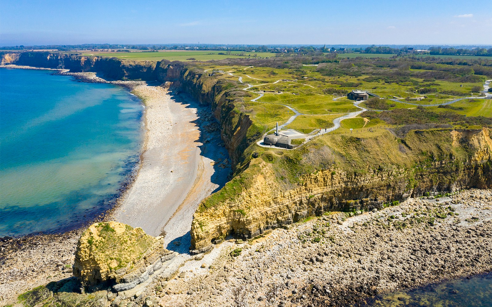 Pointe du Hoc cliffs and bunkers along Normandy coast, site of D-Day Tours.